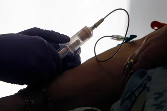 Nurse works on a patient.